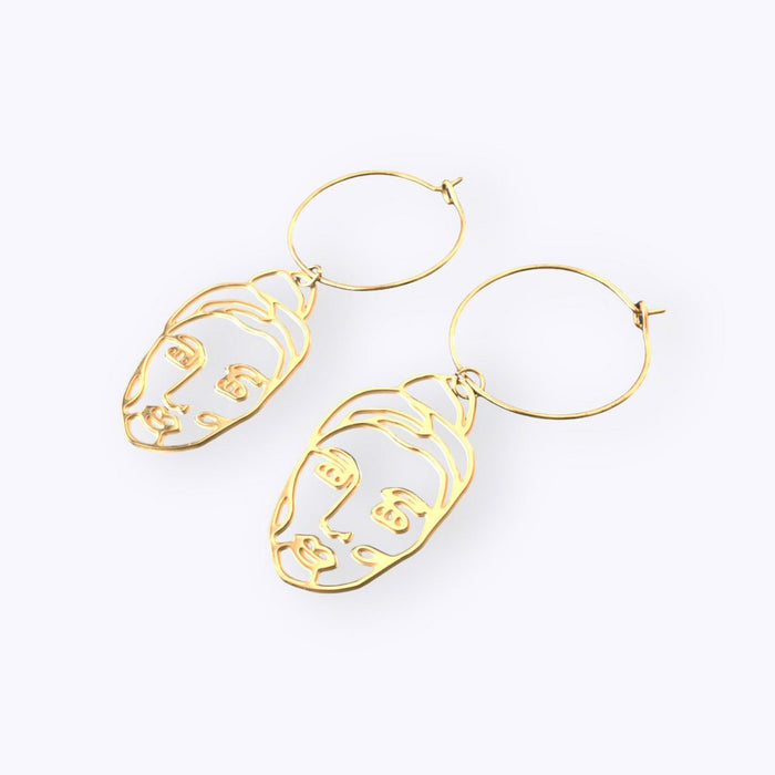 Woman golden earrings hoops